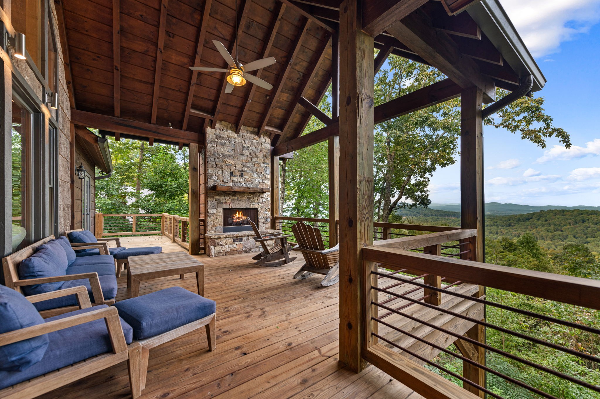 Covered deck with outdoor fireplace overlooking the Blue Ridge Mountains