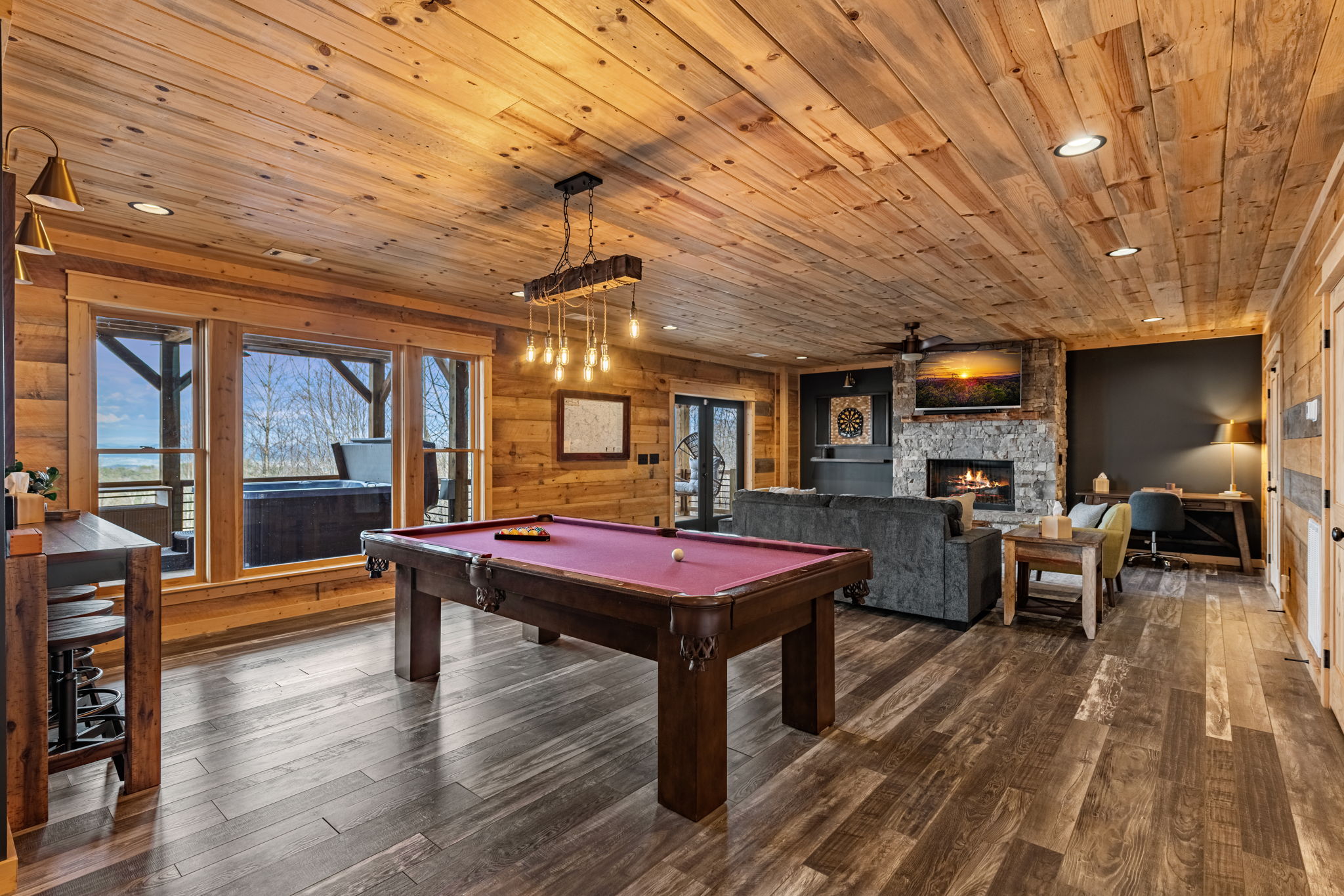 Game room with pool table stone fireplace Blue Ridge GA luxury cabin rental