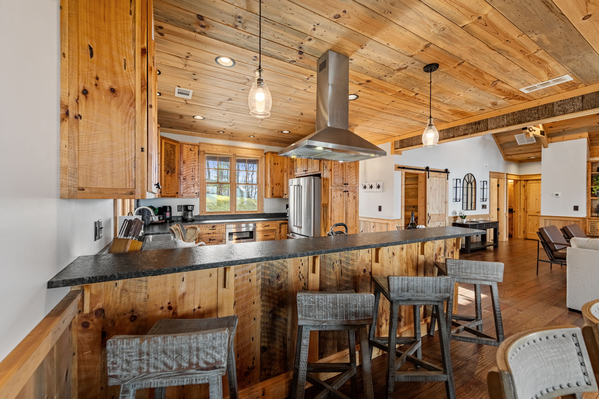 Gourmet kitchen with bar seating at luxury Blue Ridge Georgia mountain cabin rental