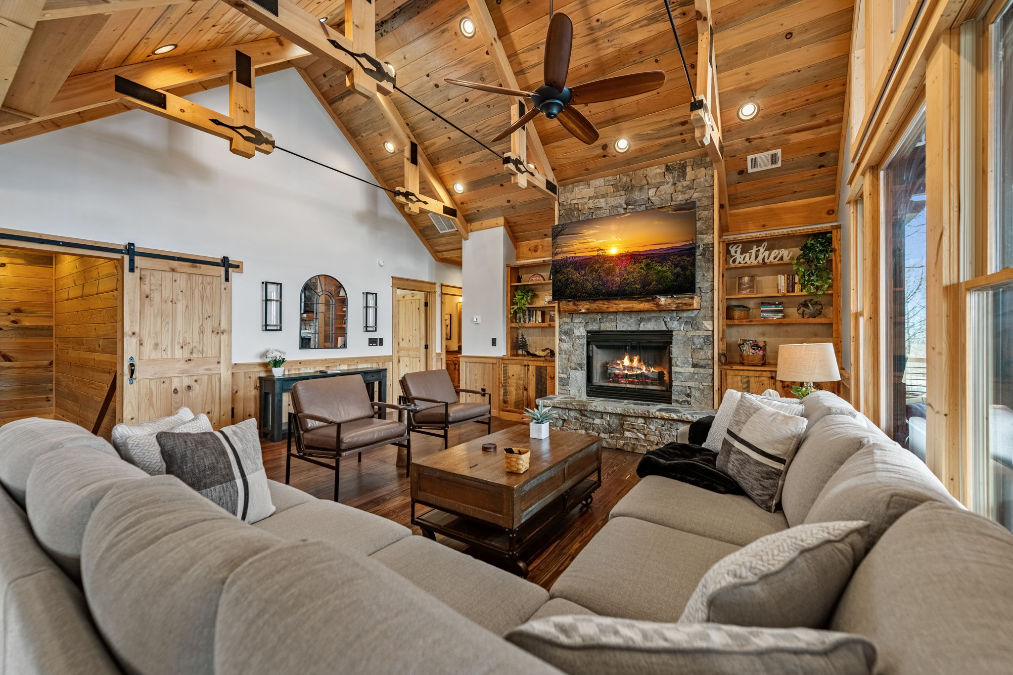 Living room with fireplace burning and Gather sign